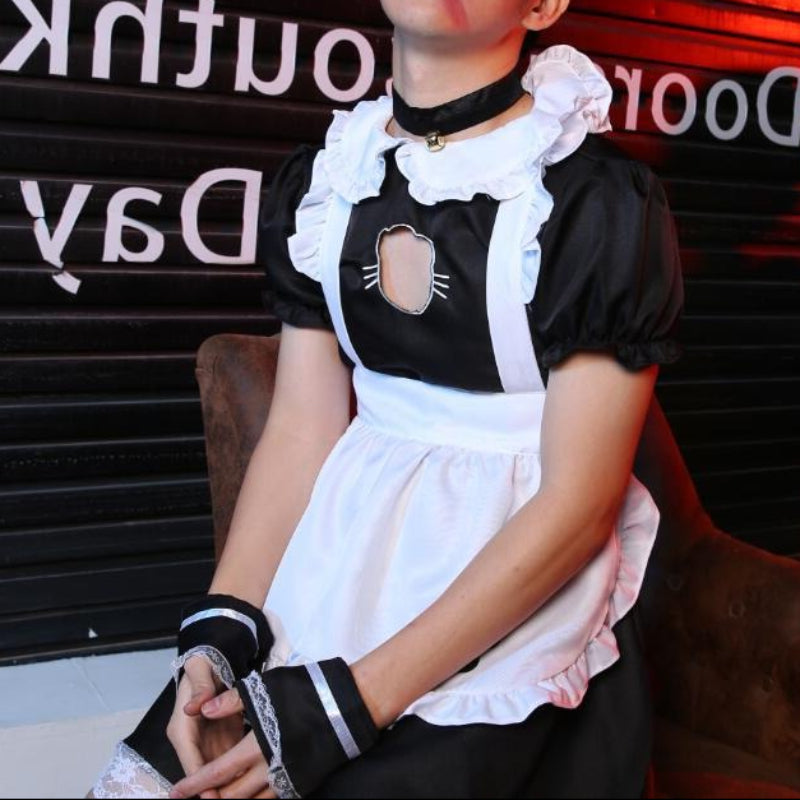 femboy wearing a maid outfit sitting on a chair with a blurred background