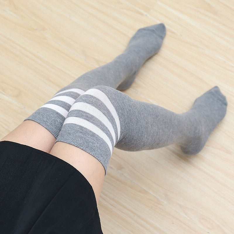 femboy thighs in light gray white striped thigh highs