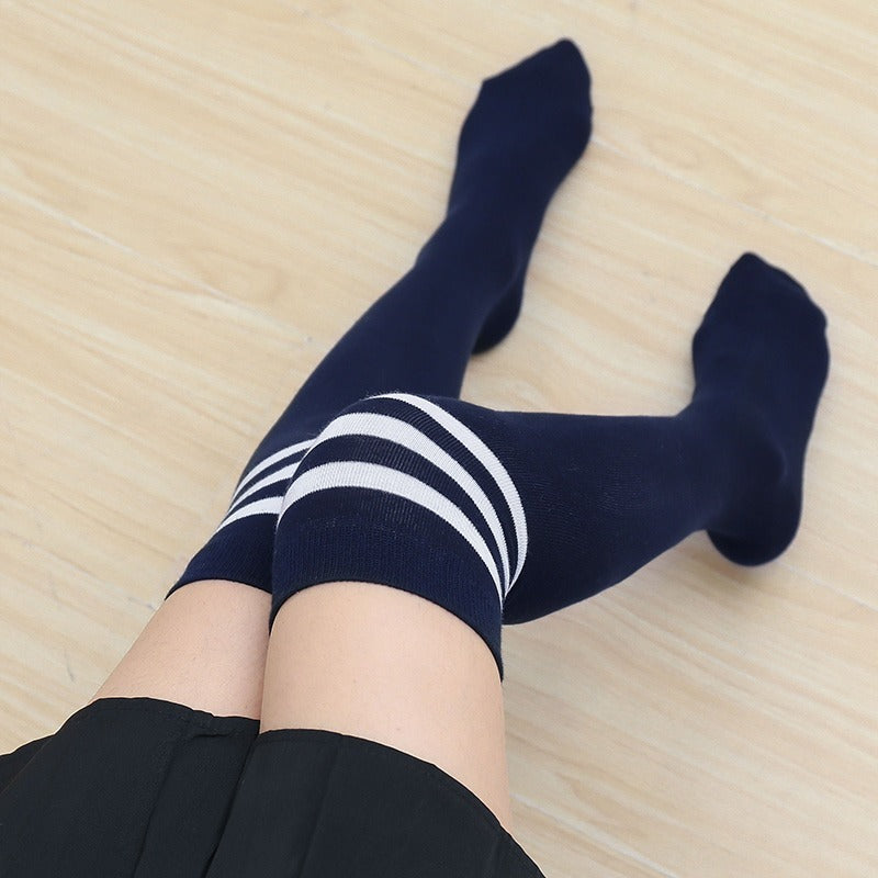 femboy thighs in navy blue white striped thigh highs