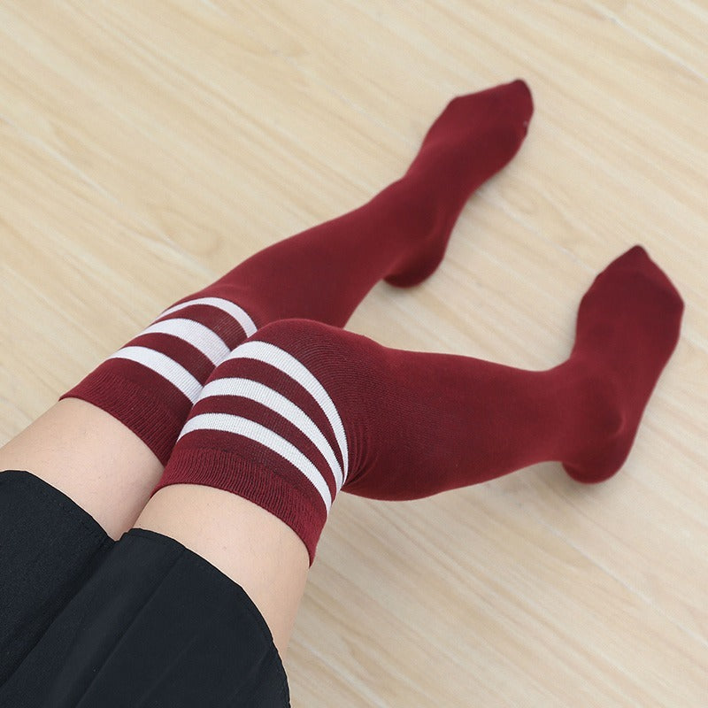 femboy thighs in red white striped thigh highs